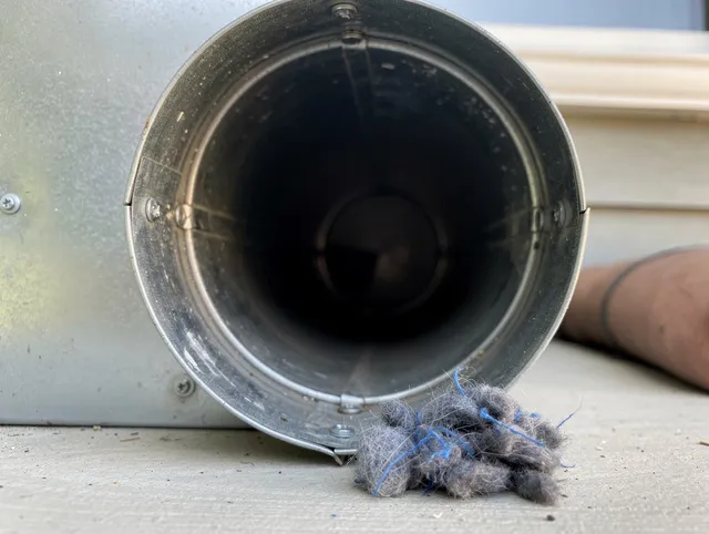 Wareham Dryer Vent Cleaning technician using specialized equipment to clear severe dryer vent blockage in Wareham